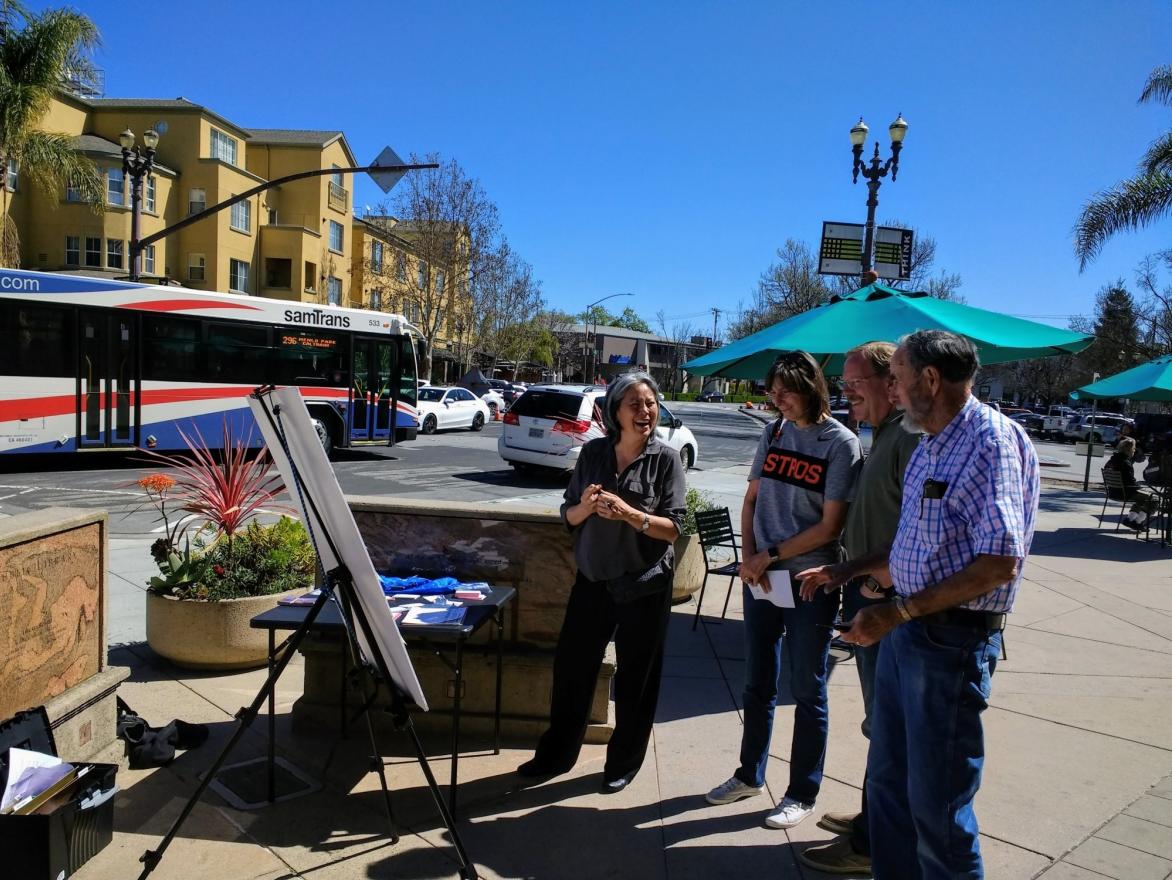 Community members in Redwood City talk to MTC staff about the project.