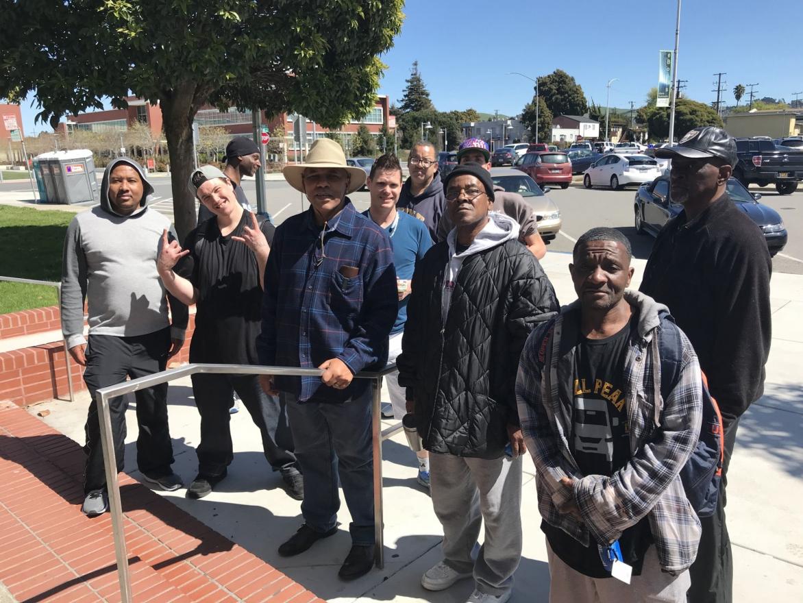 Community members stop to share their ideas in front of the Richmond library.