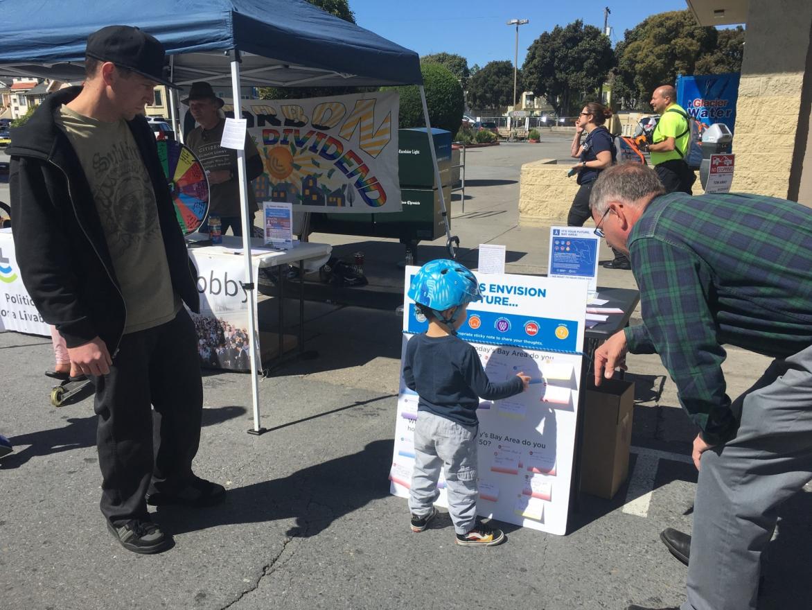 At Sunday Streets in the Excelsior, a young bike rider helps us with our project.