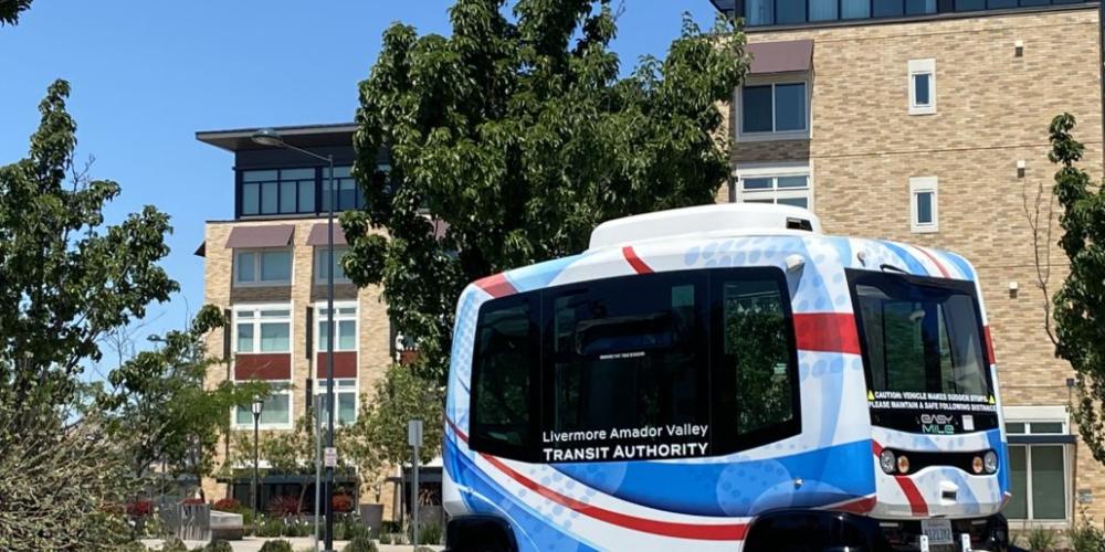 shuttle bus in front of buildings