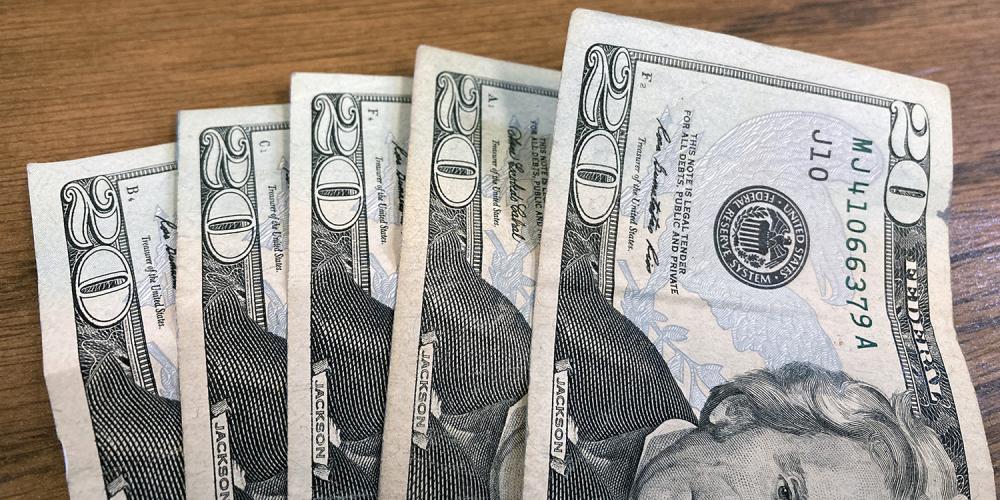 Five U.S. twenty dollar bills.