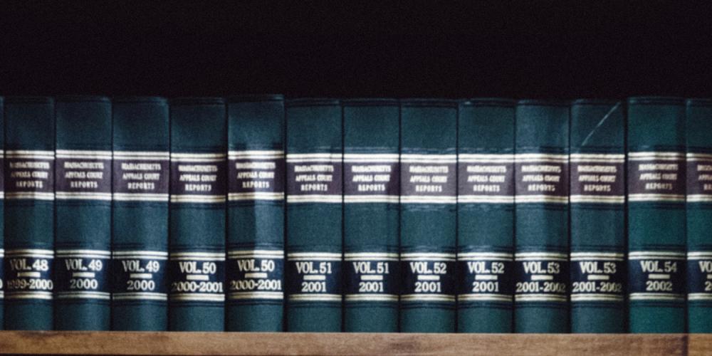 A shelf with a row of law books.