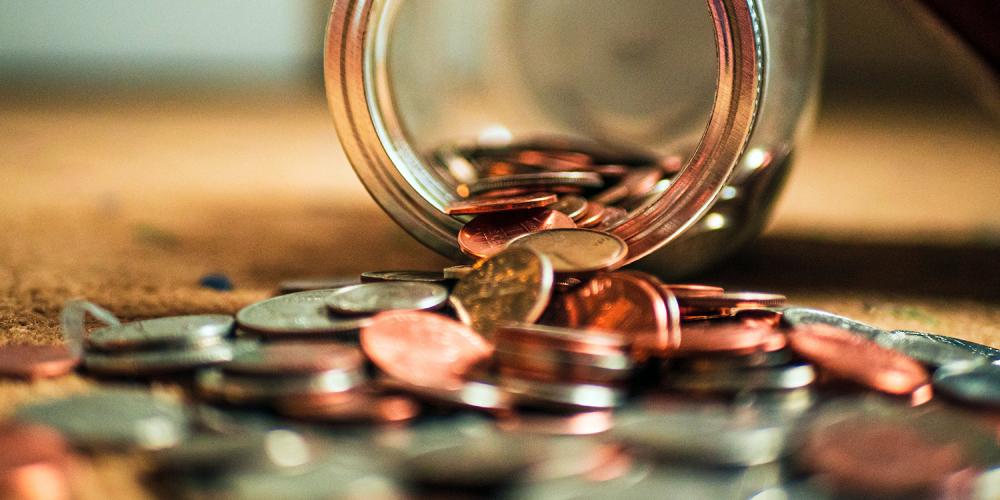 A jar spilling out coins.