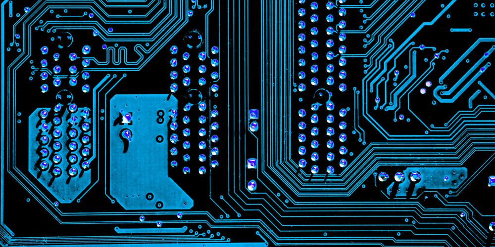 Close up of a computer circuit board, image tinted blue.