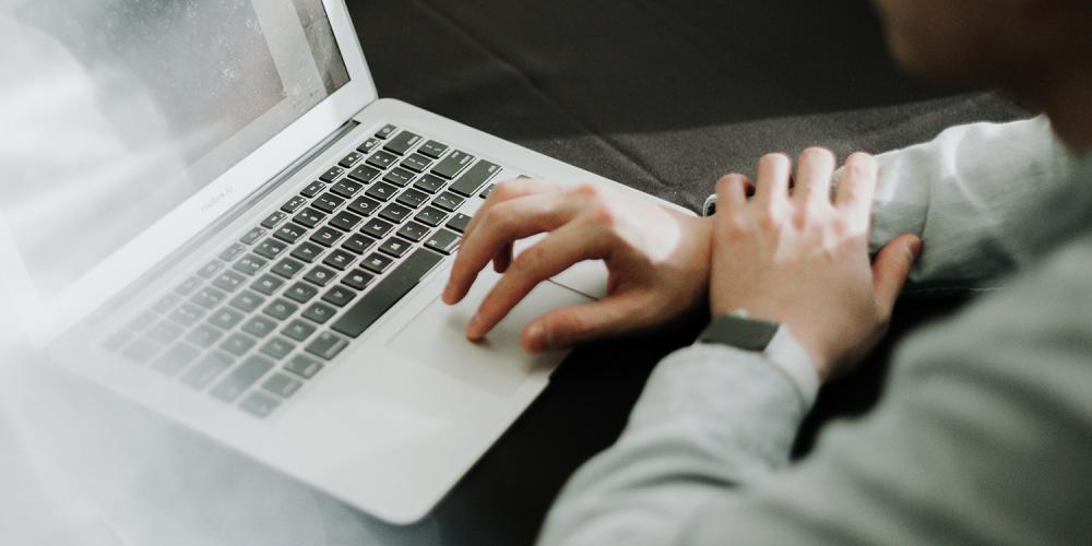 A person using a laptop computer.
