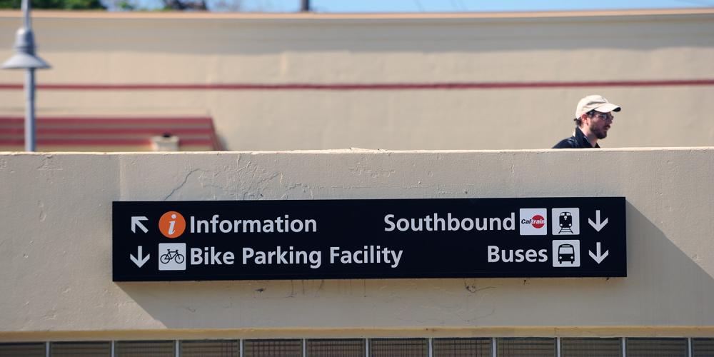 Informational sign at Palo Alto Caltrain station for transit connections and bike parking.