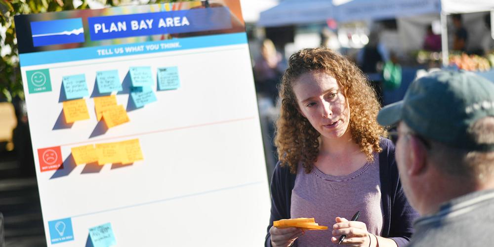MTC/ABAG staff talking with members of the public at a Plan Bay Area pop-up event.
