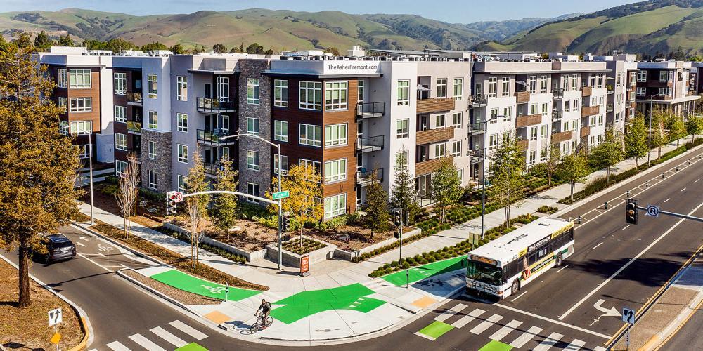 Artistic rendering of new buildings behind greenspace.