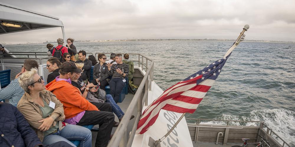 San Francisco Bay Ferry passengers and an American flag.