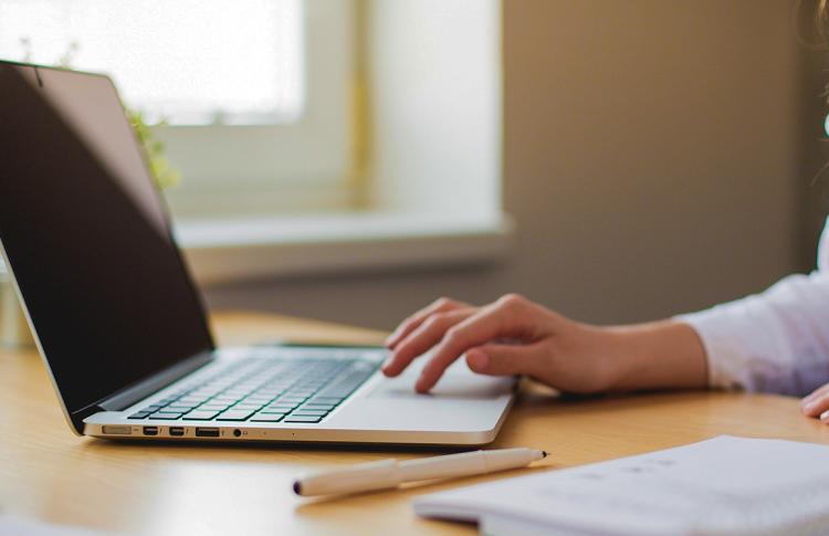 A person using a laptop computer.