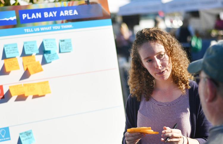 MTC/ABAG staff talking with members of the public at a Plan Bay Area pop-up event.