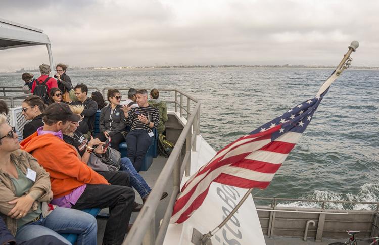 San Francisco Bay Ferry passengers and an American flag.
