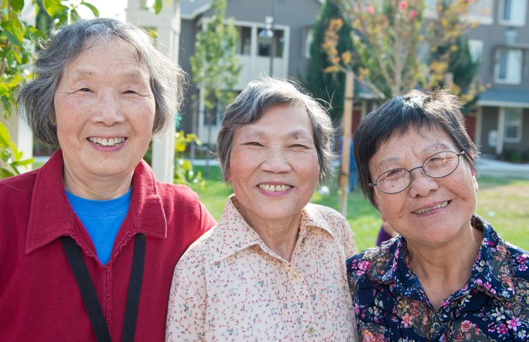 Three smiling Asian senior women.