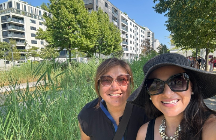ABAG president Belia Ramos and another woman sit in front of Vienna's public housing