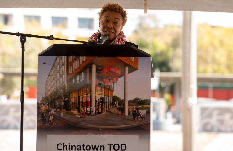 Representative Barbara Lee speaks at a podium 
