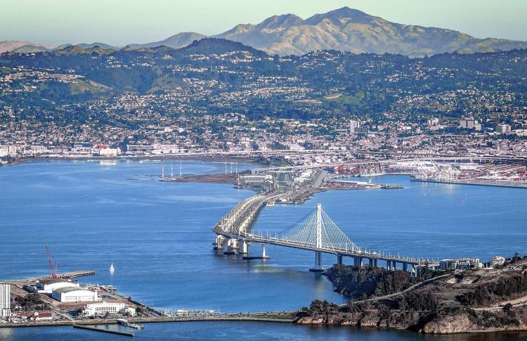 Aerial over the San Francisco-Oakland Bay Bridge and East Bay.
