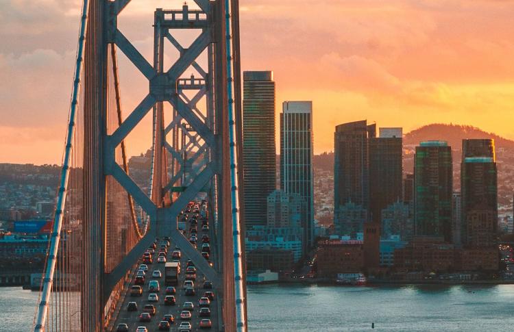 Bay Bridge looking at San Francisco from Treasure Island at sunset with traffic